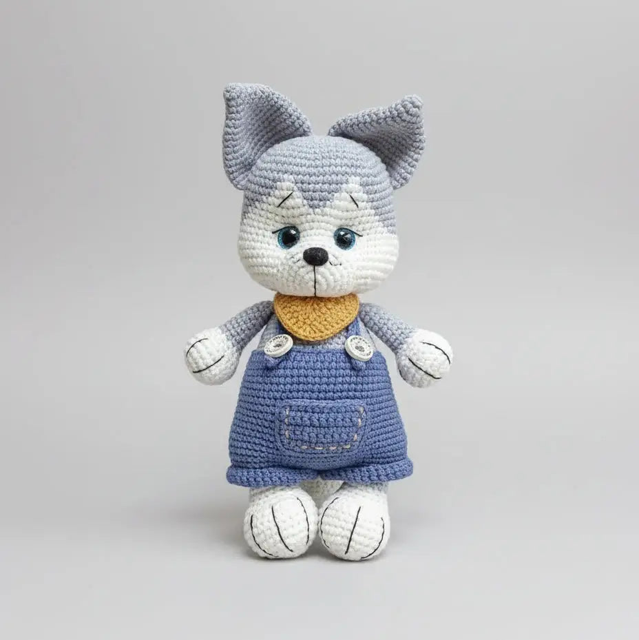 Crocheted gray and white cat doll with blue dress and yellow collar