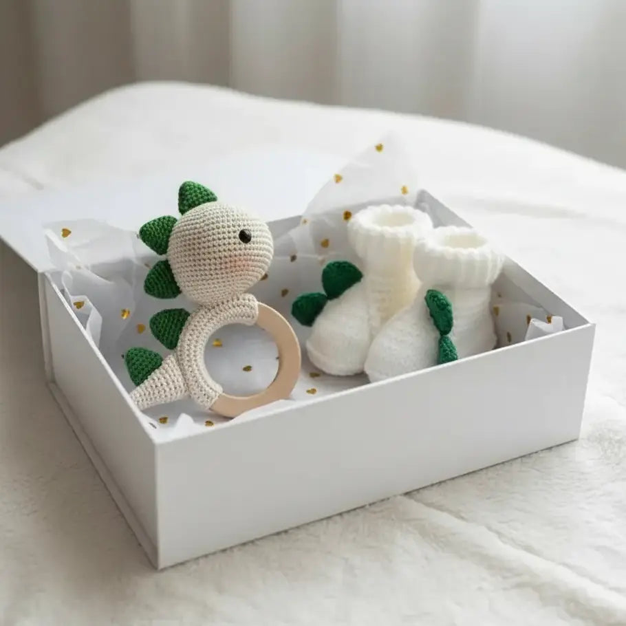 Crochet Cute Dino Rattle and Dino Baby Booties Gift Set featuring a charming dinosaur rattle and matching baby booties, perfect for little ones who love dinosaurs.