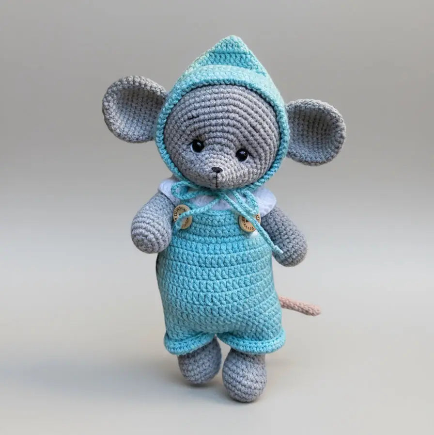 Crocheted gray mouse in blue overalls and hooded top with wooden buttons