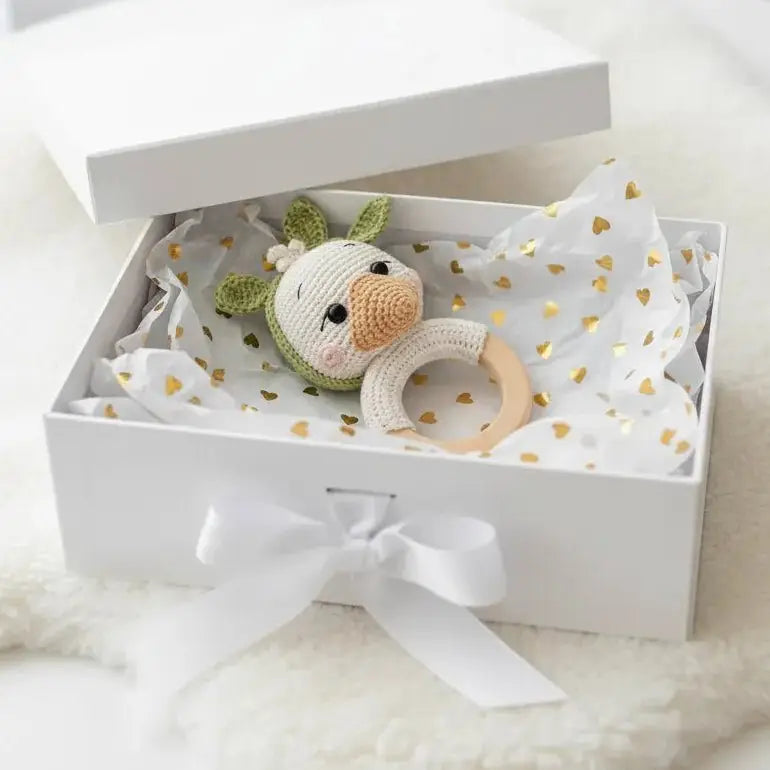 Crocheted bunny rattle with wooden ring in white gift box with gold heart tissue paper