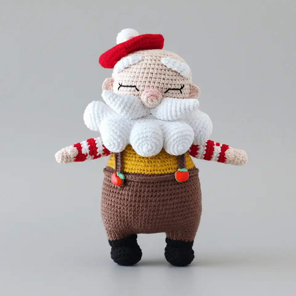 Crocheted gnome with red hat, white beard, yellow sweater, and brown overalls.