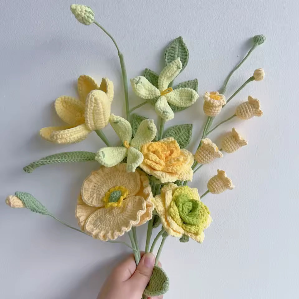 Crocheted bouquet of yellow and green flowers with delicate textured petals and stems