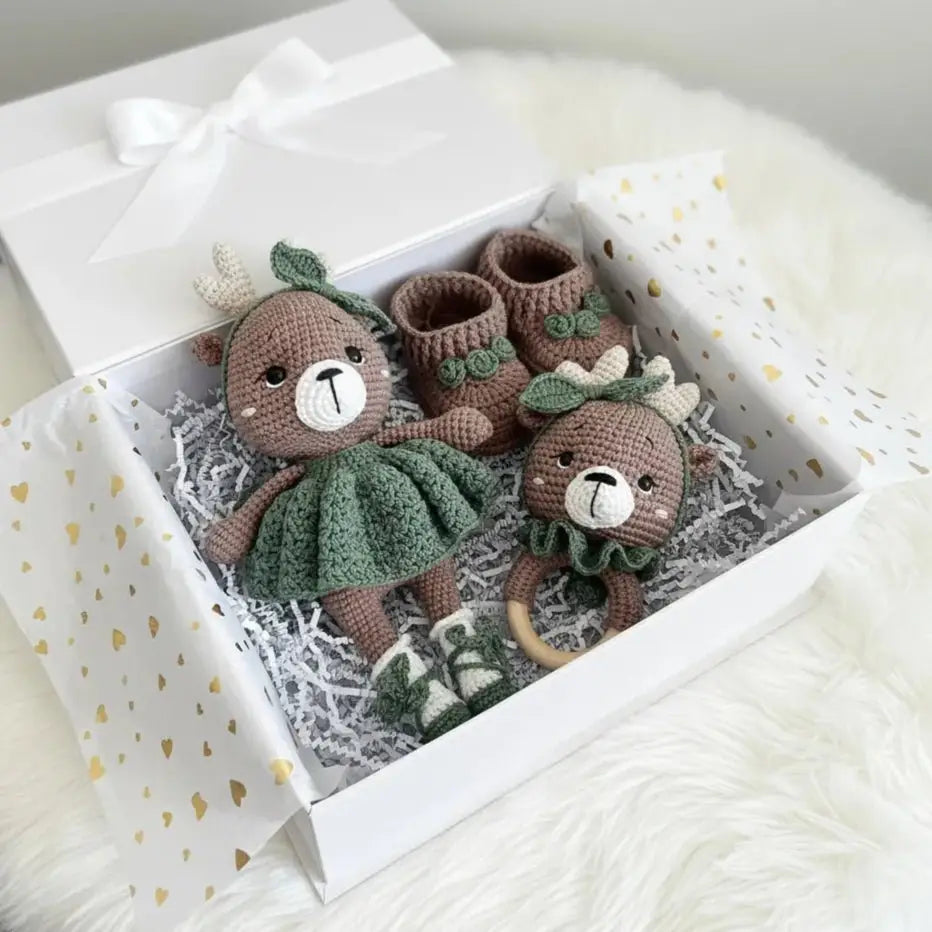Handmade crochet bears, booties, and rattle in a white gift box with gold hearts