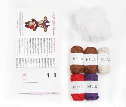 Knitting pattern and colorful yarn skeins labeled "Hello" on a white background