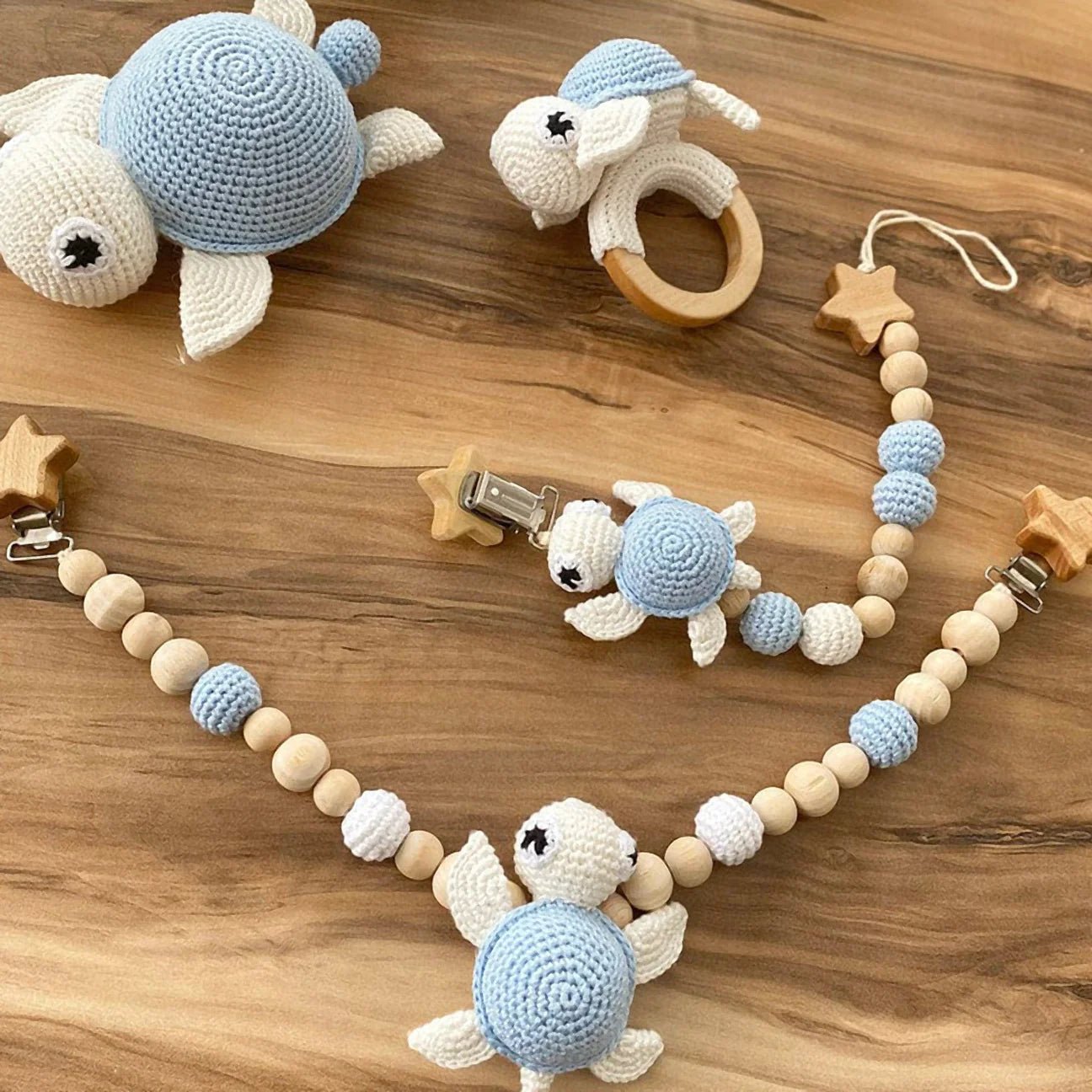 Crocheted blue and white turtle baby toys with wooden beads and star clips
