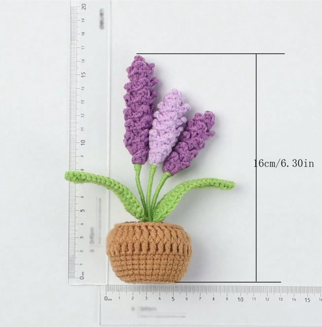Crocheted lavender plant in brown pot, purple and green yarn, measured on ruler