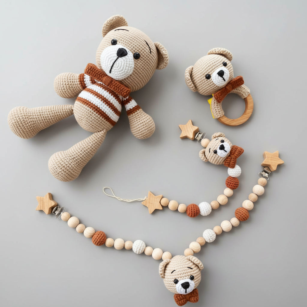 Crocheted teddy bears with wooden star stroller accessories on green leaf background