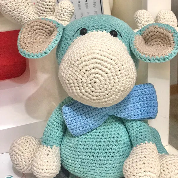 a crocheted stuffed animal with a blue bow tie