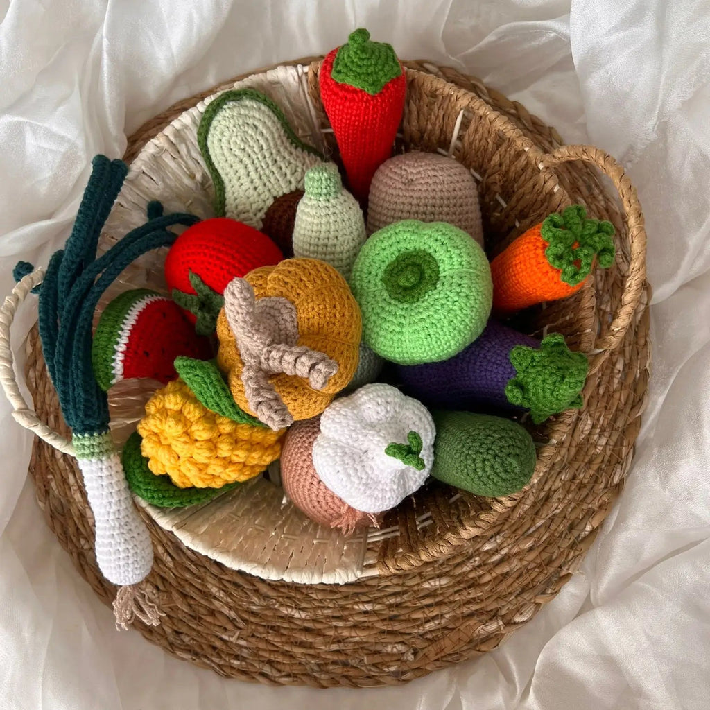 Crocheted vegetables and fruits in a woven basket, colorful and handmade craft display
