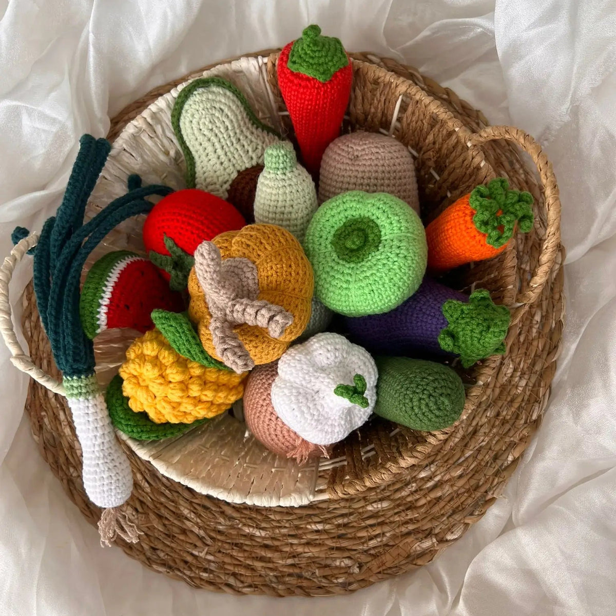 Crocheted vegetables and fruits in a woven basket, colorful and handmade craft display
