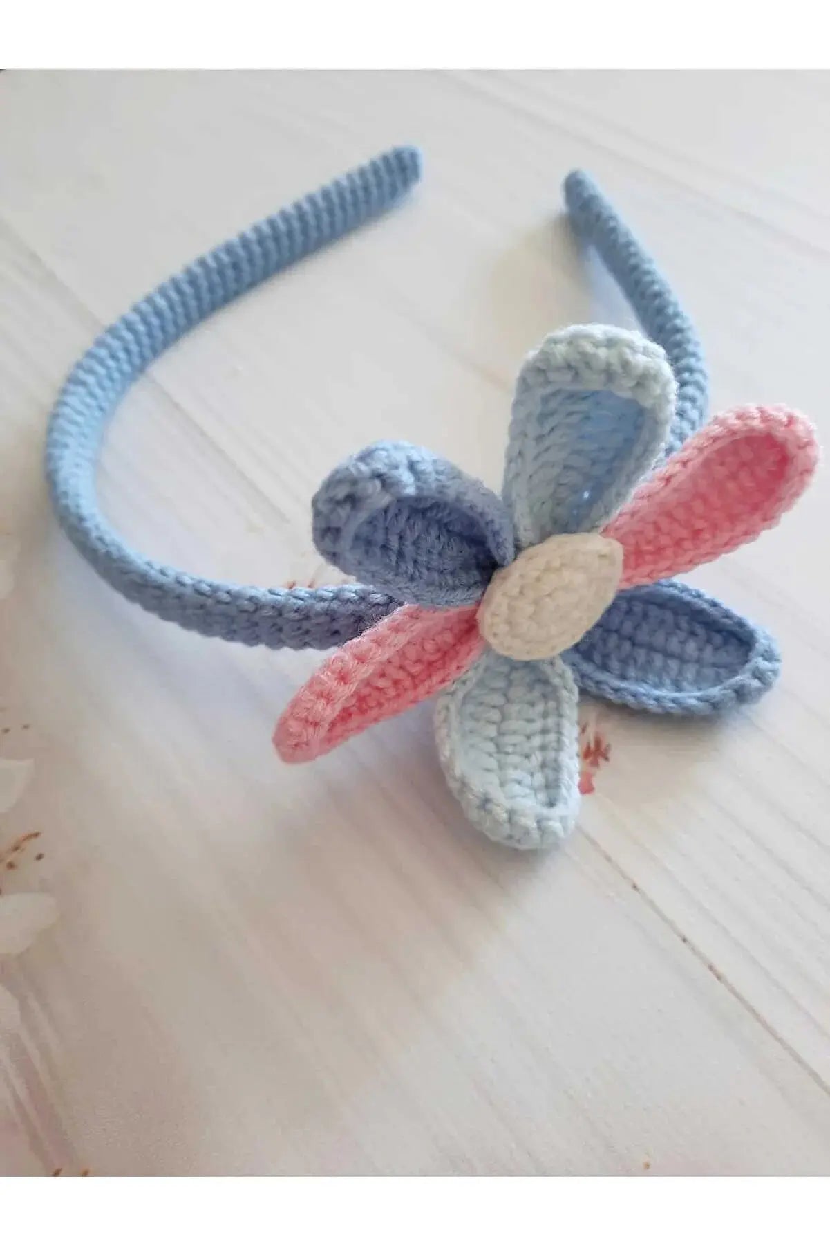 a crocheted flower headband on a table