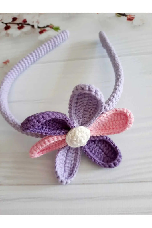 a crocheted headband with a flower on it