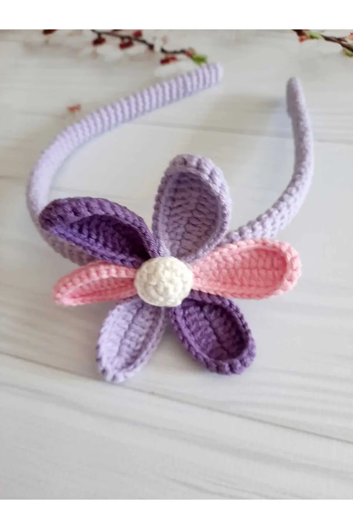 a crocheted headband with a flower on it