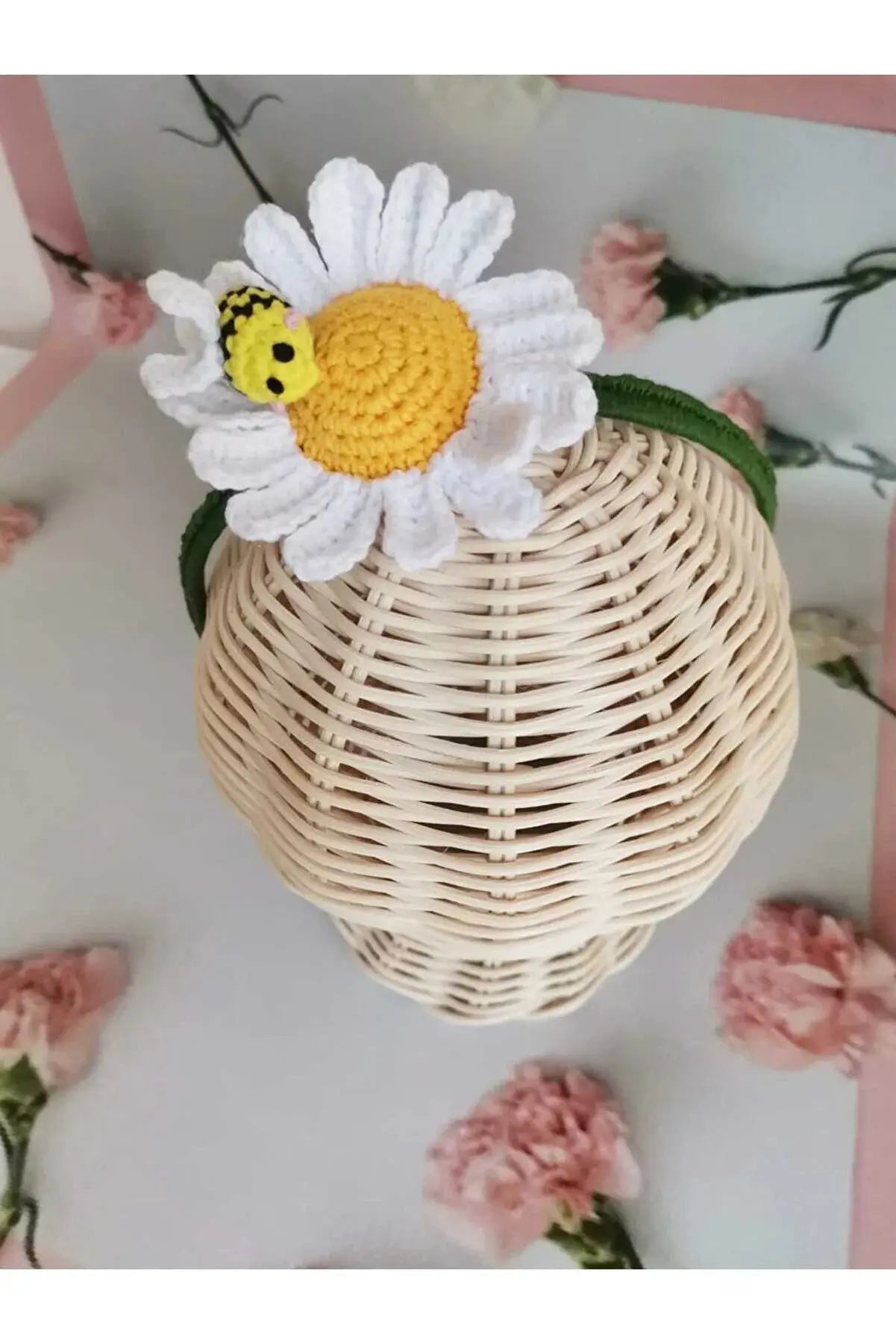 a basket with a flower on top of it