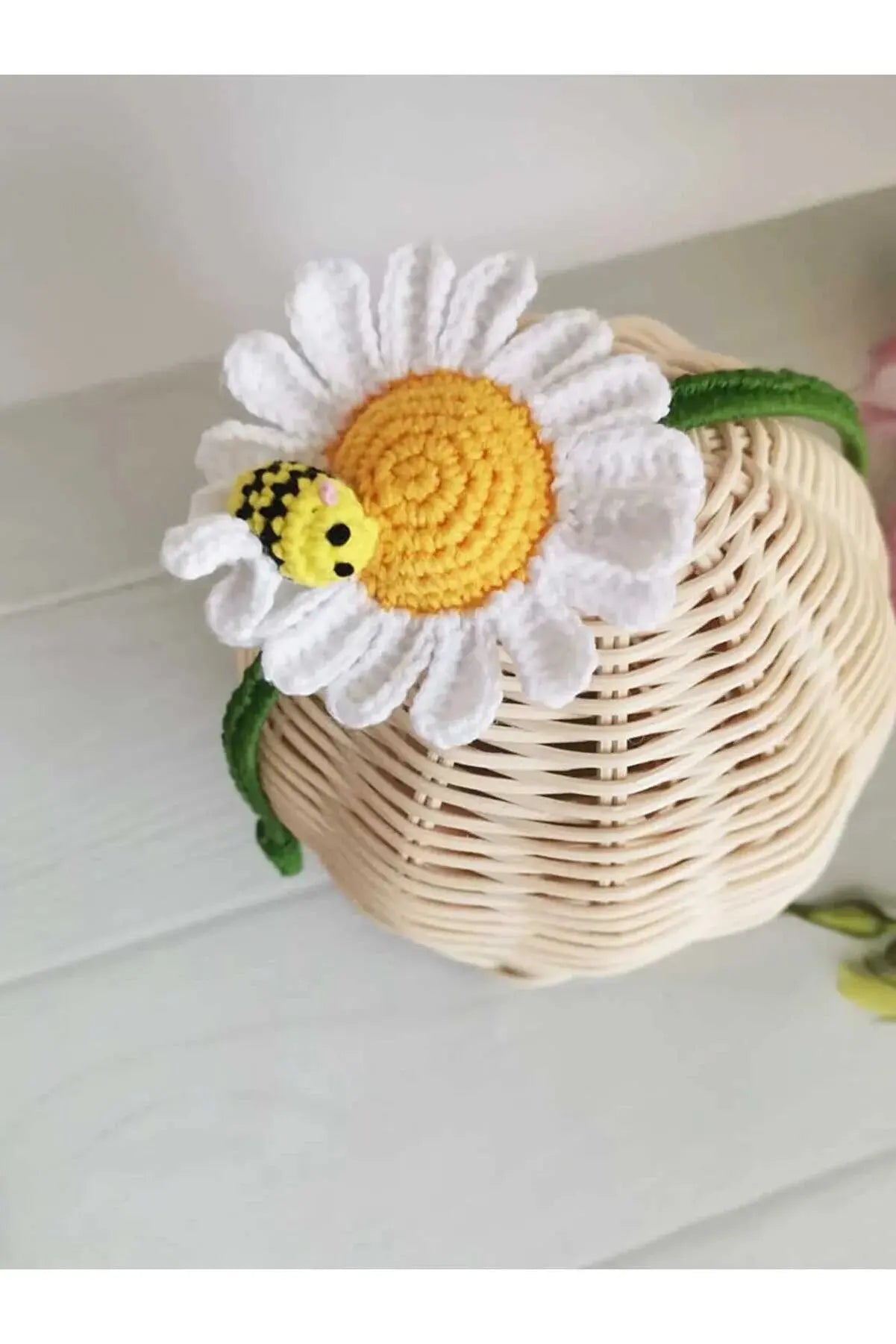 a basket with a flower and a bee on it