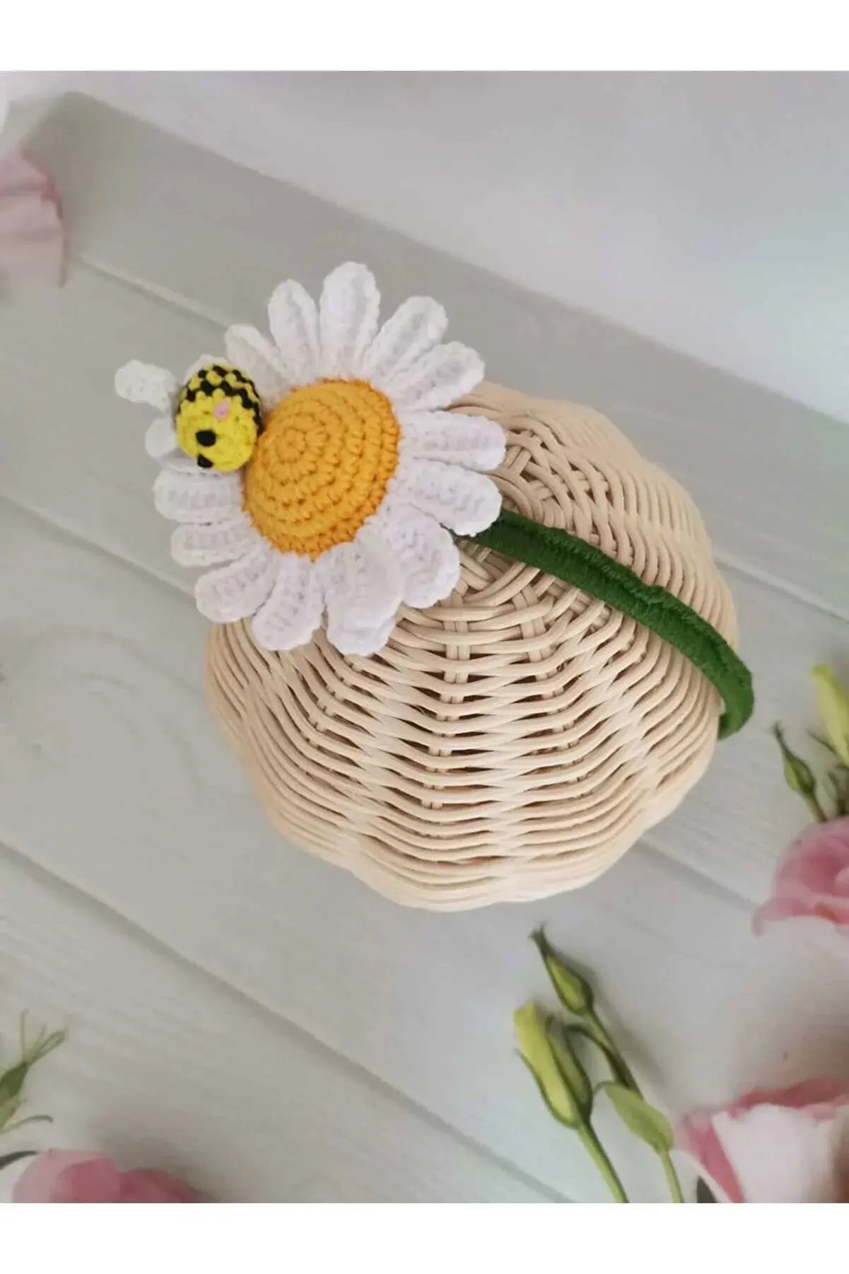 a basket with a flower and a bee on it