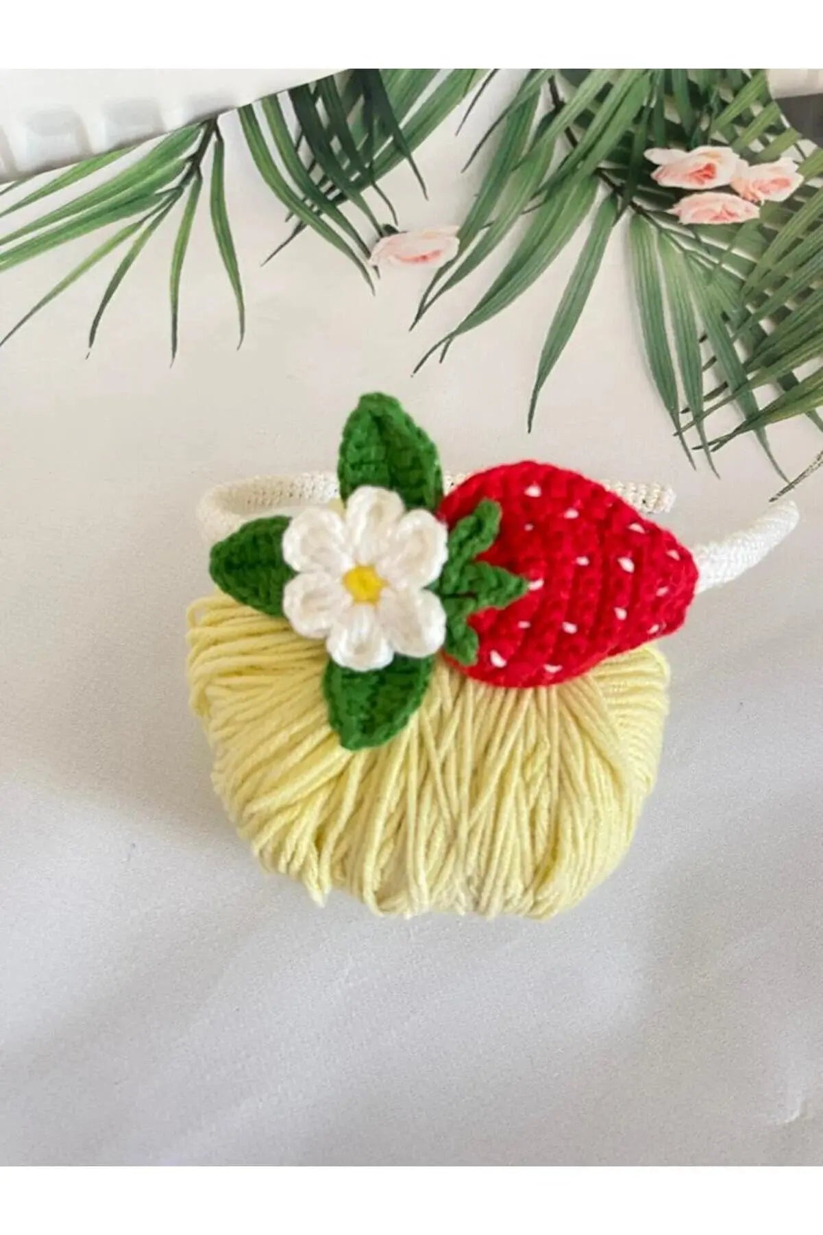 a crocheted straw hat with a flower on it