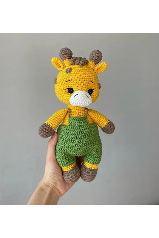 a crocheted giraffe stuffed animal in a green and yellow outfit