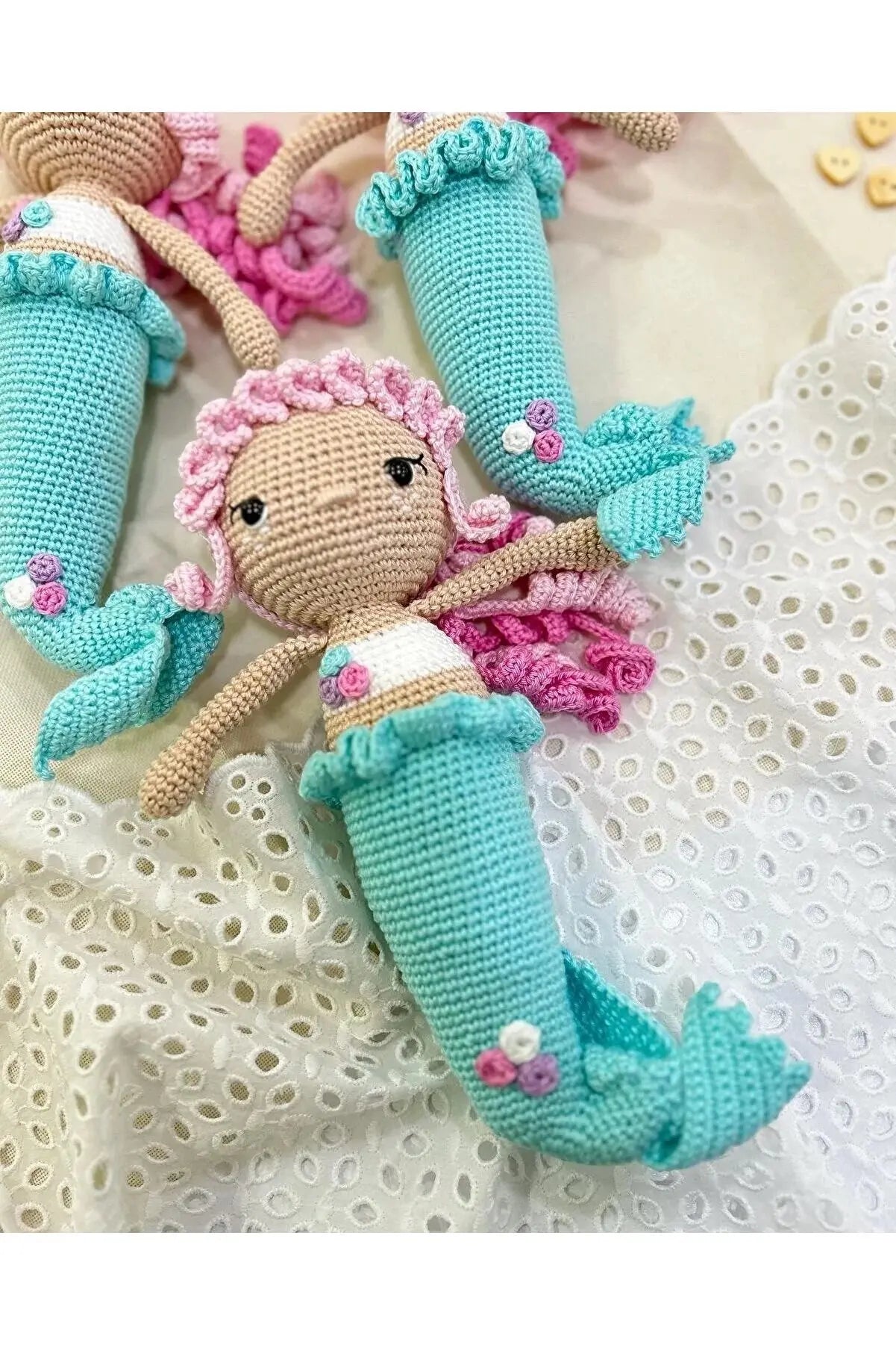 a crocheted doll laying on top of a bed