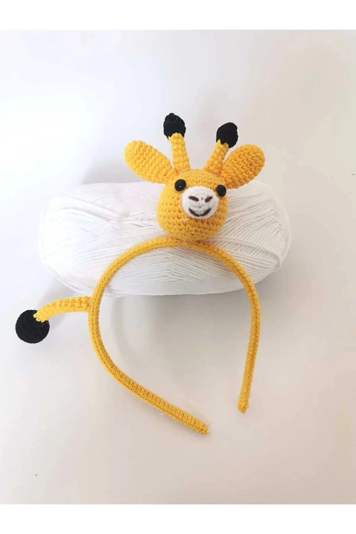 a crocheted headband with a giraffe on top of it