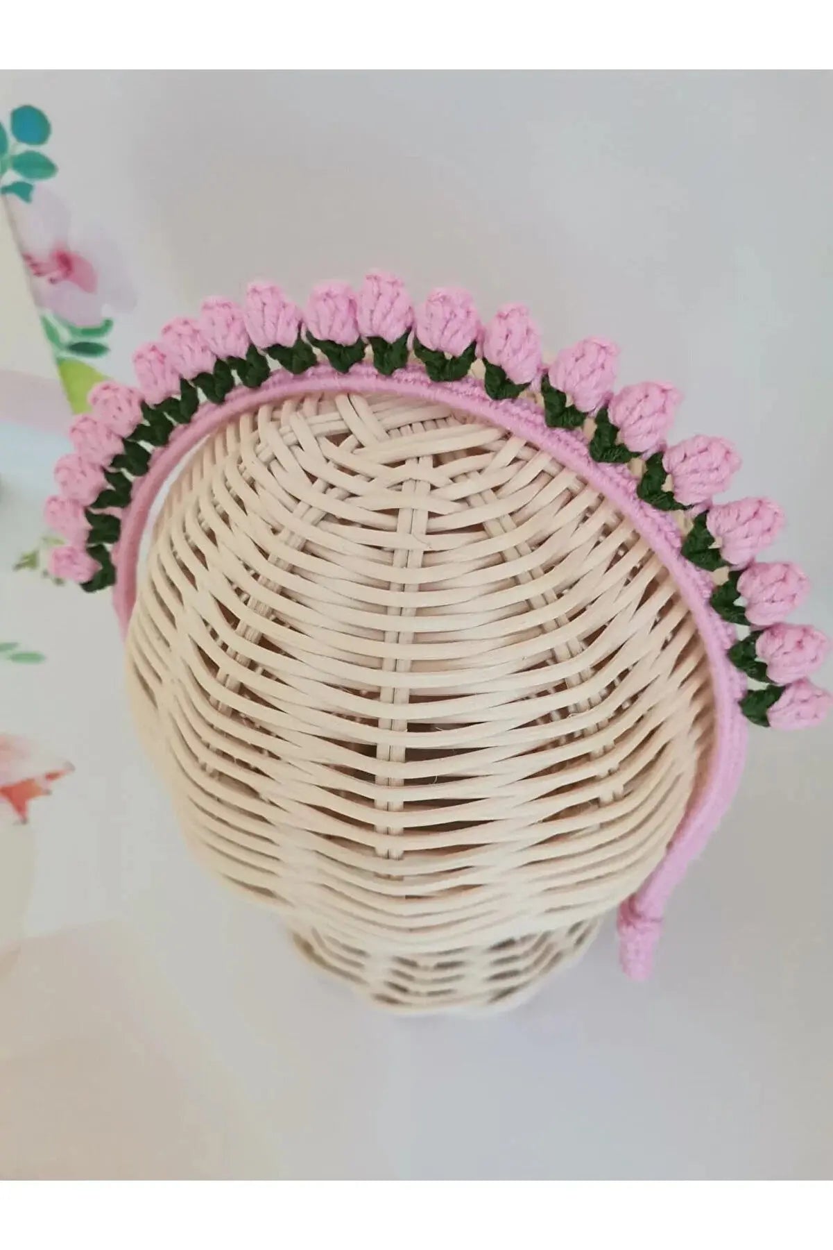 a white wicker basket with pink flowers on it