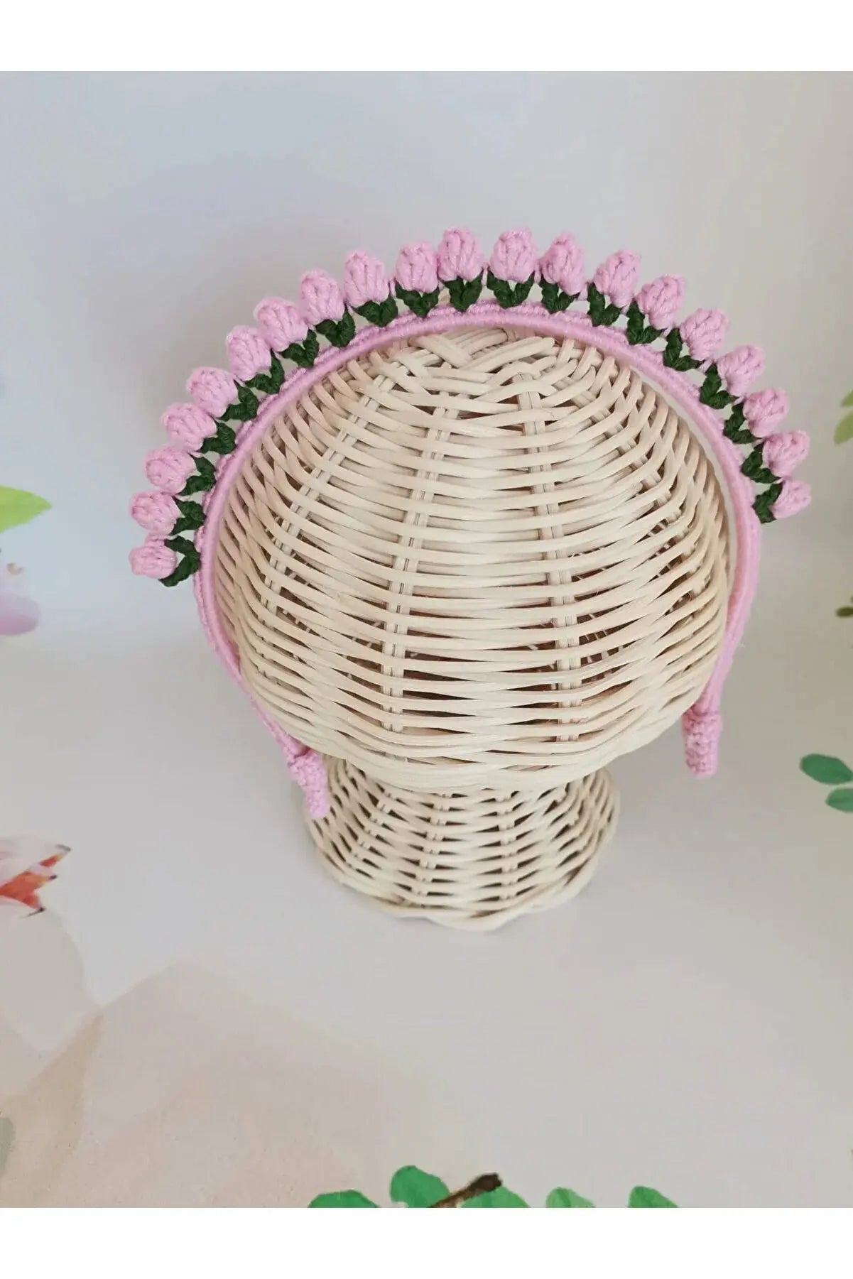 a white wicker hat with pink flowers on it