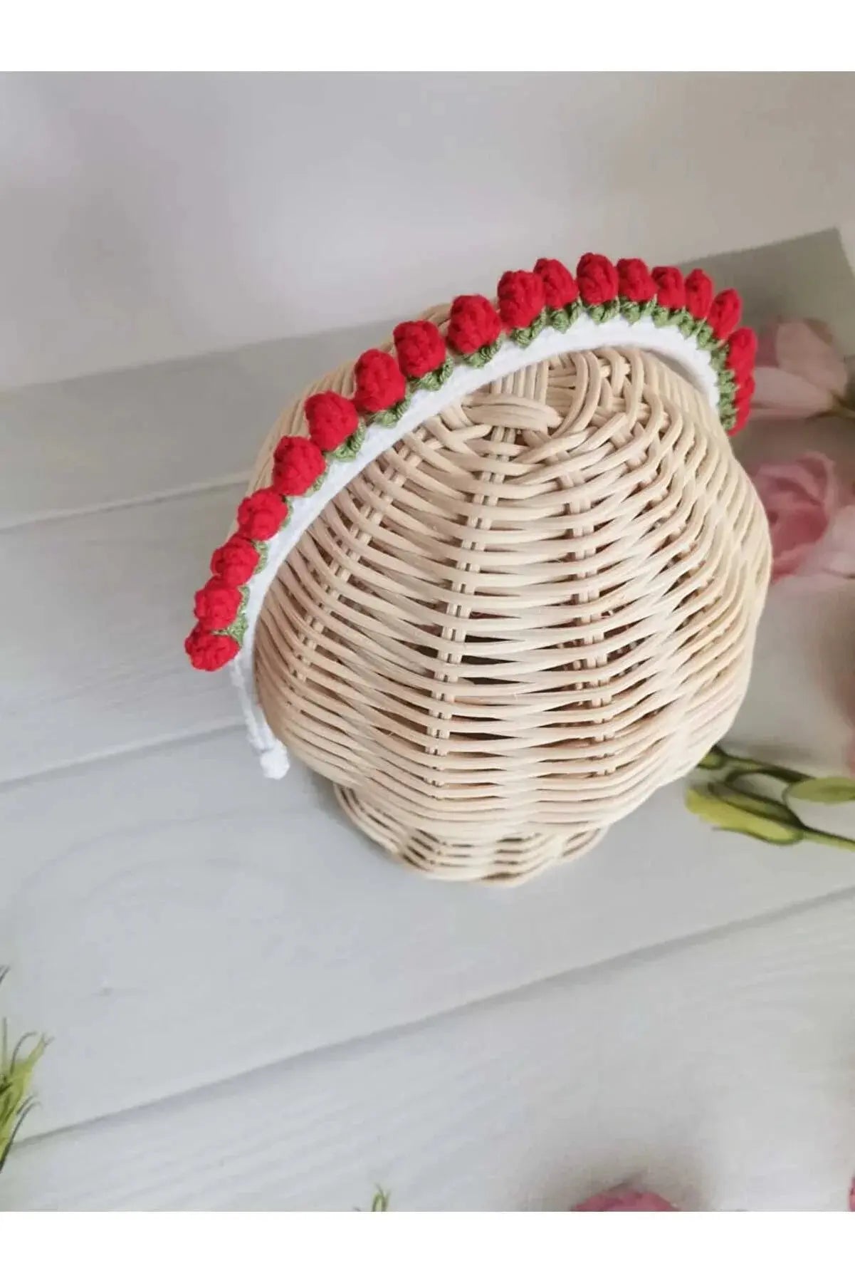 a white wicker basket with red flowers on it