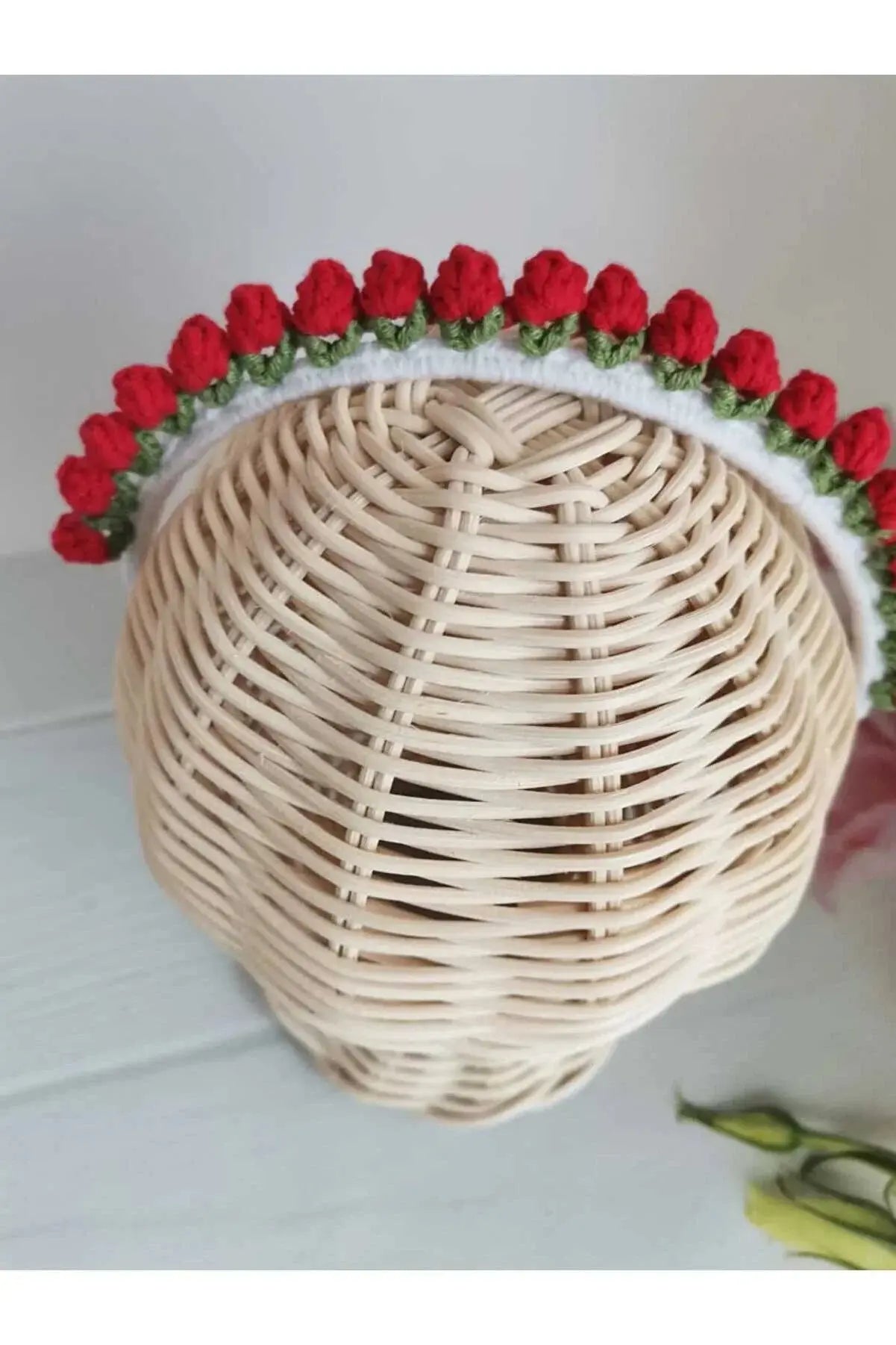 a white wicker basket with red roses on it