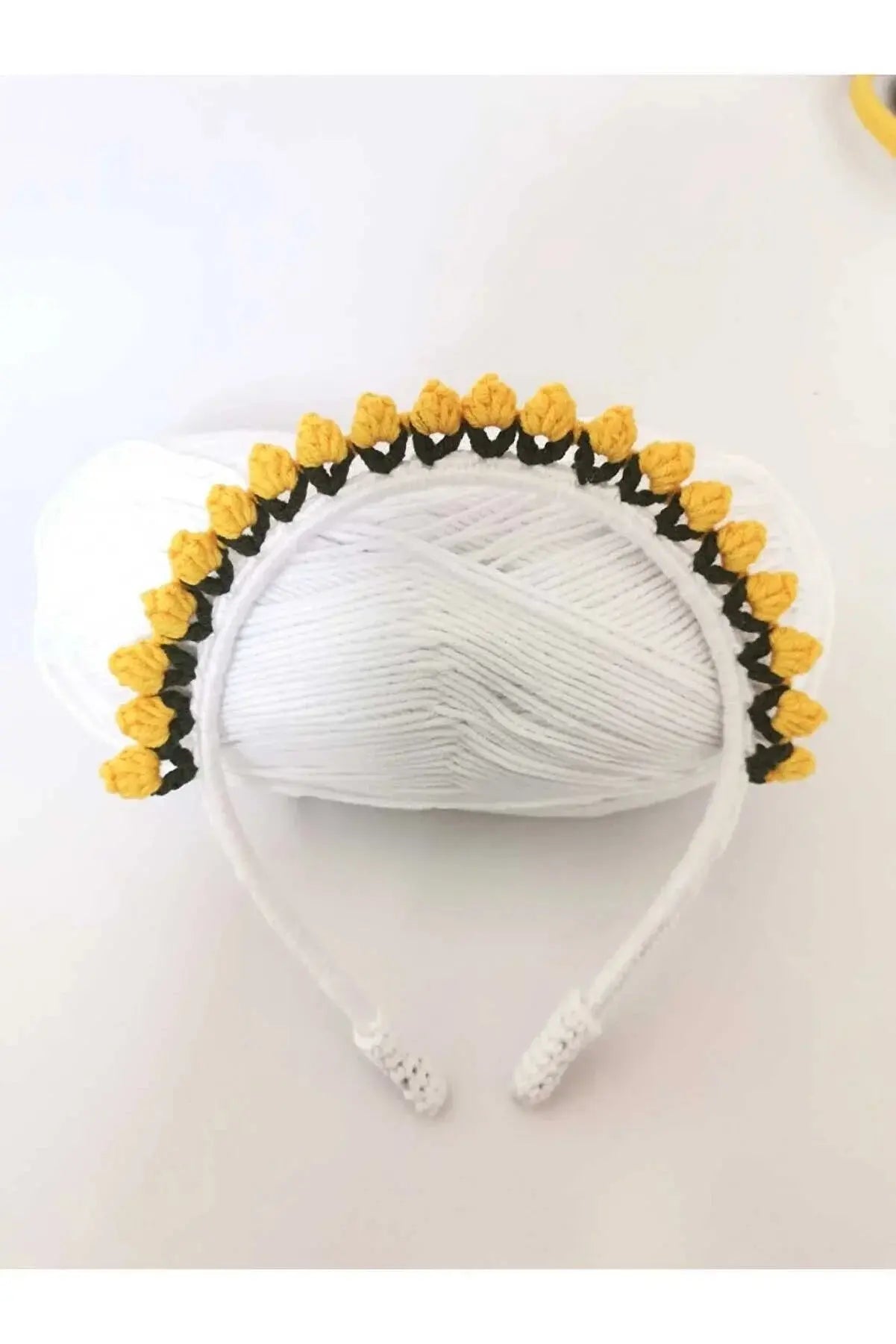 a white headband with yellow flowers on it