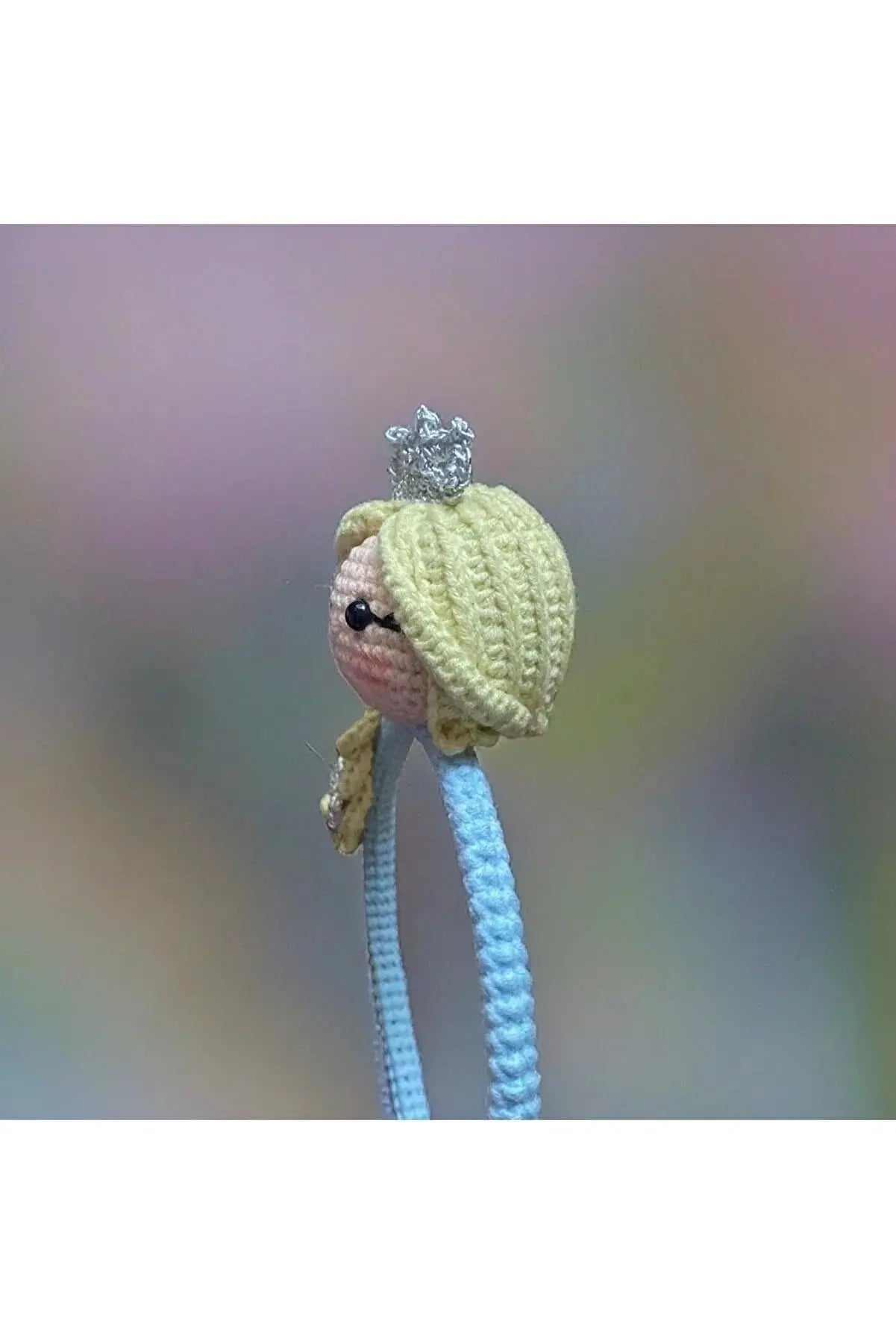 a knitted doll with a crown on it's head