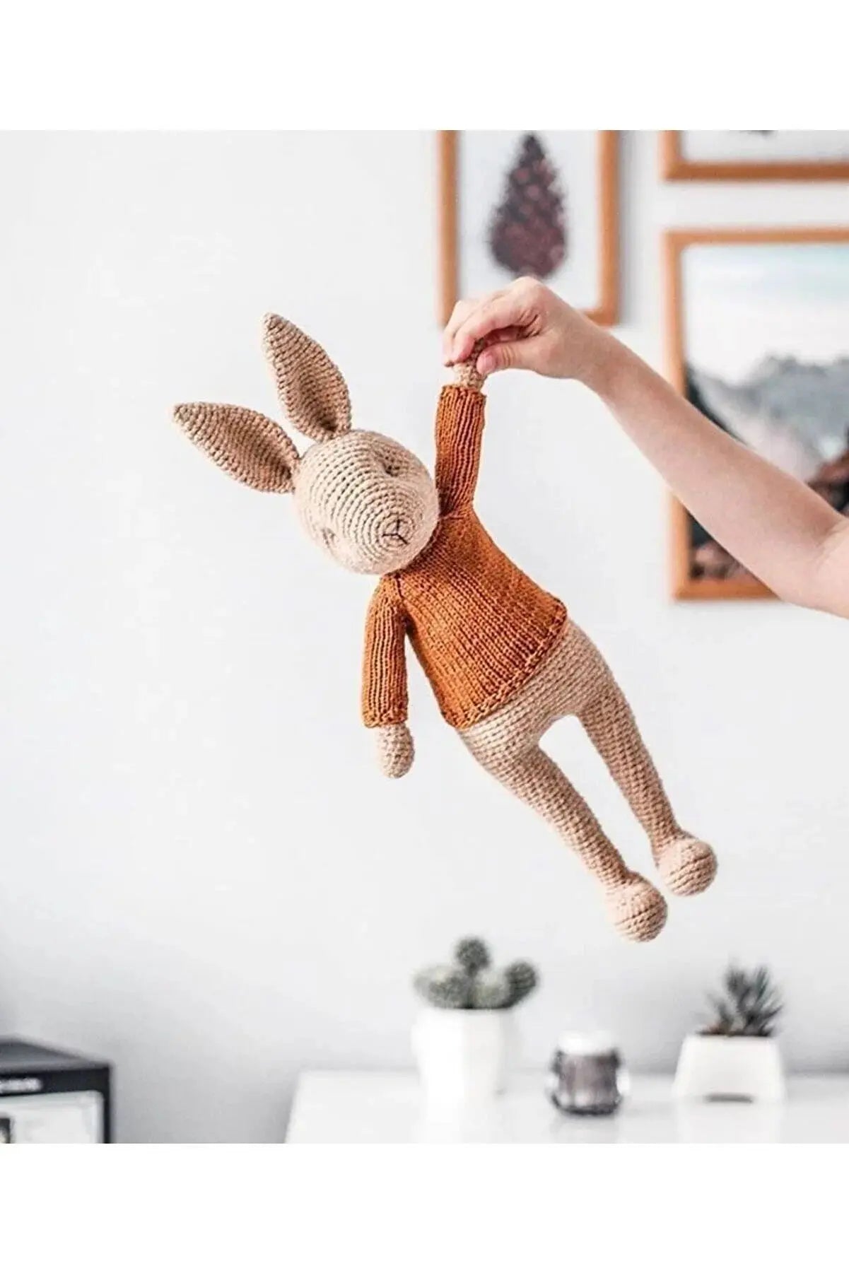 a person holding a stuffed animal in the air