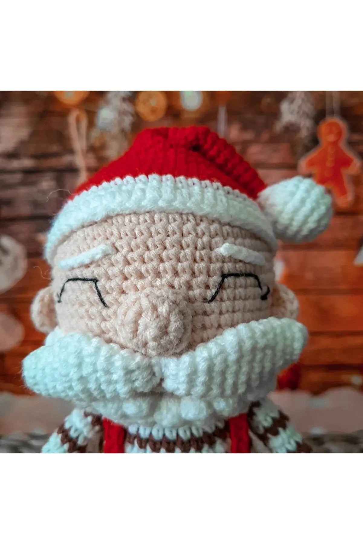 a crocheted santa clause doll with a red hat and beard