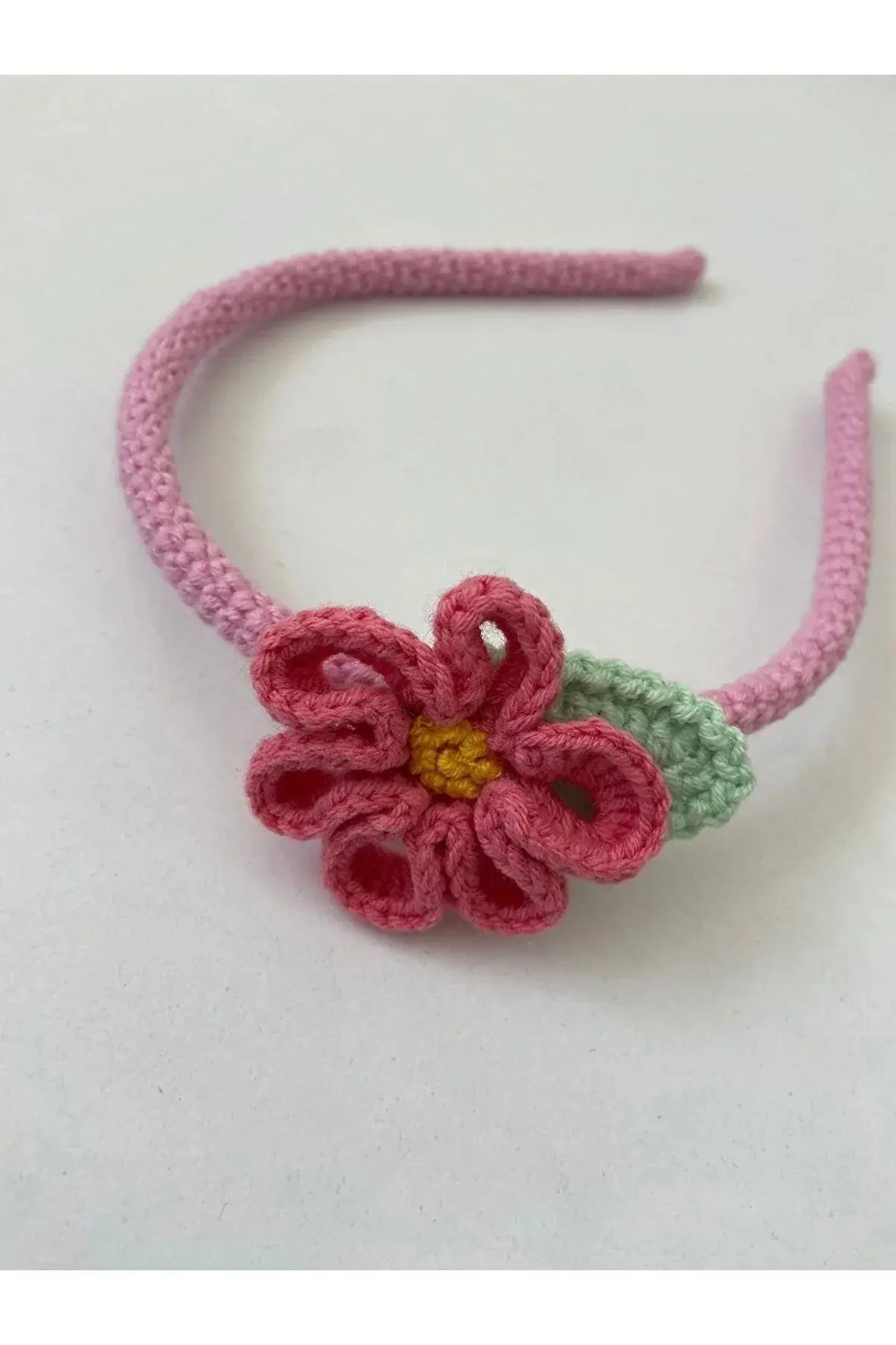 a crocheted headband with a flower on it