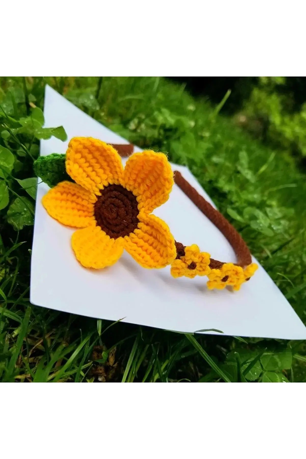 a crocheted flower on a piece of paper