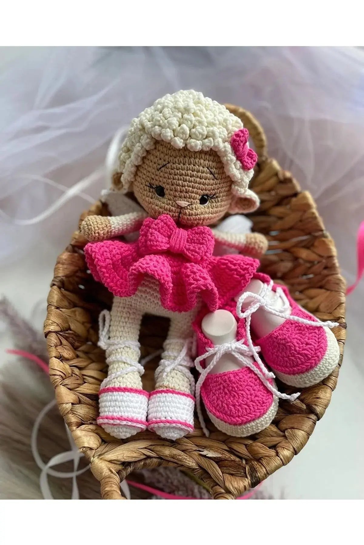 a crocheted doll sitting in a basket