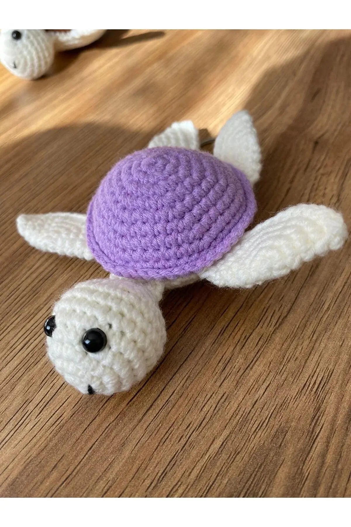 a crocheted turtle on a wooden table