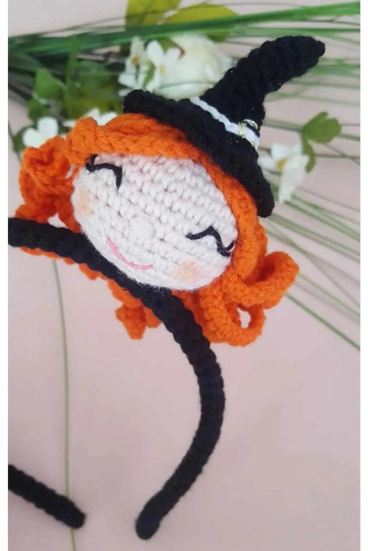 a crocheted doll with a witches hat