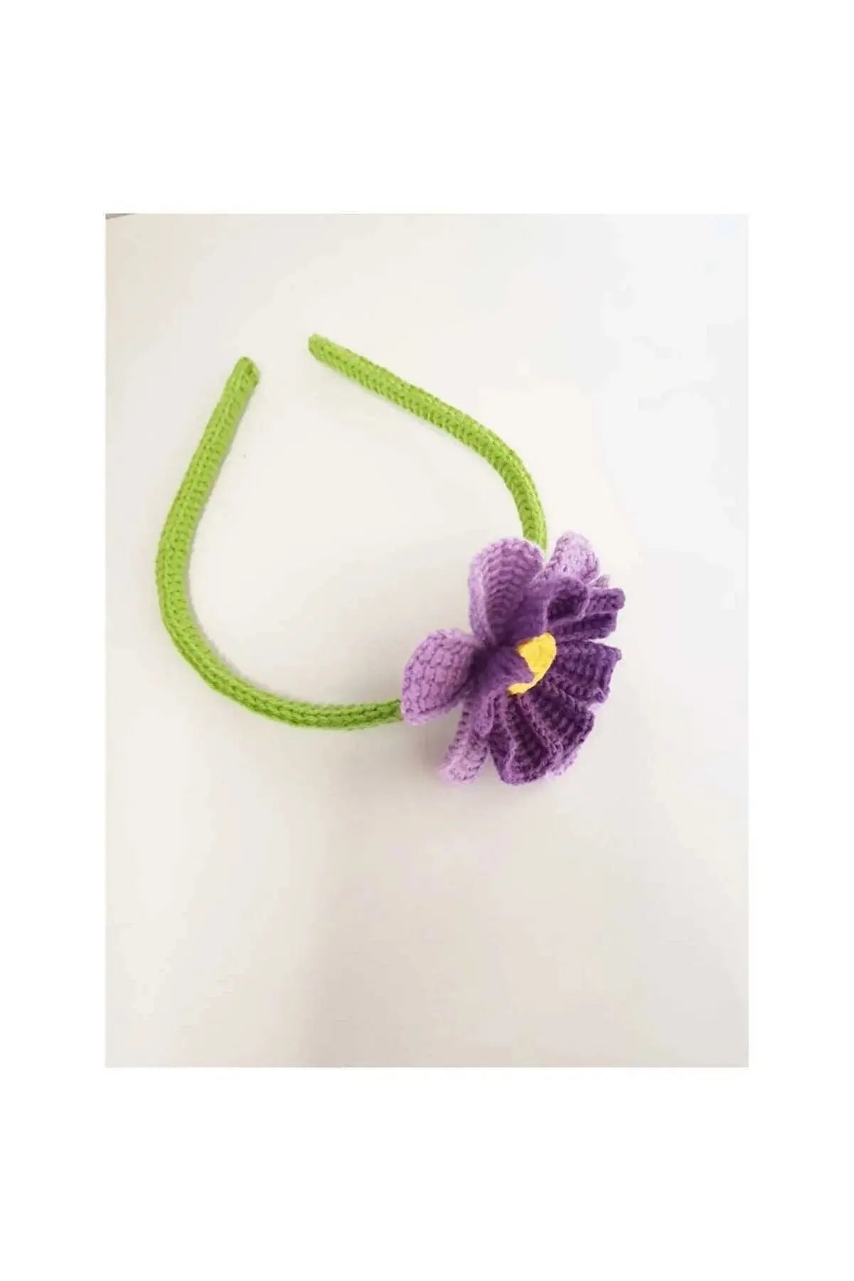 a crocheted headband with a flower on it