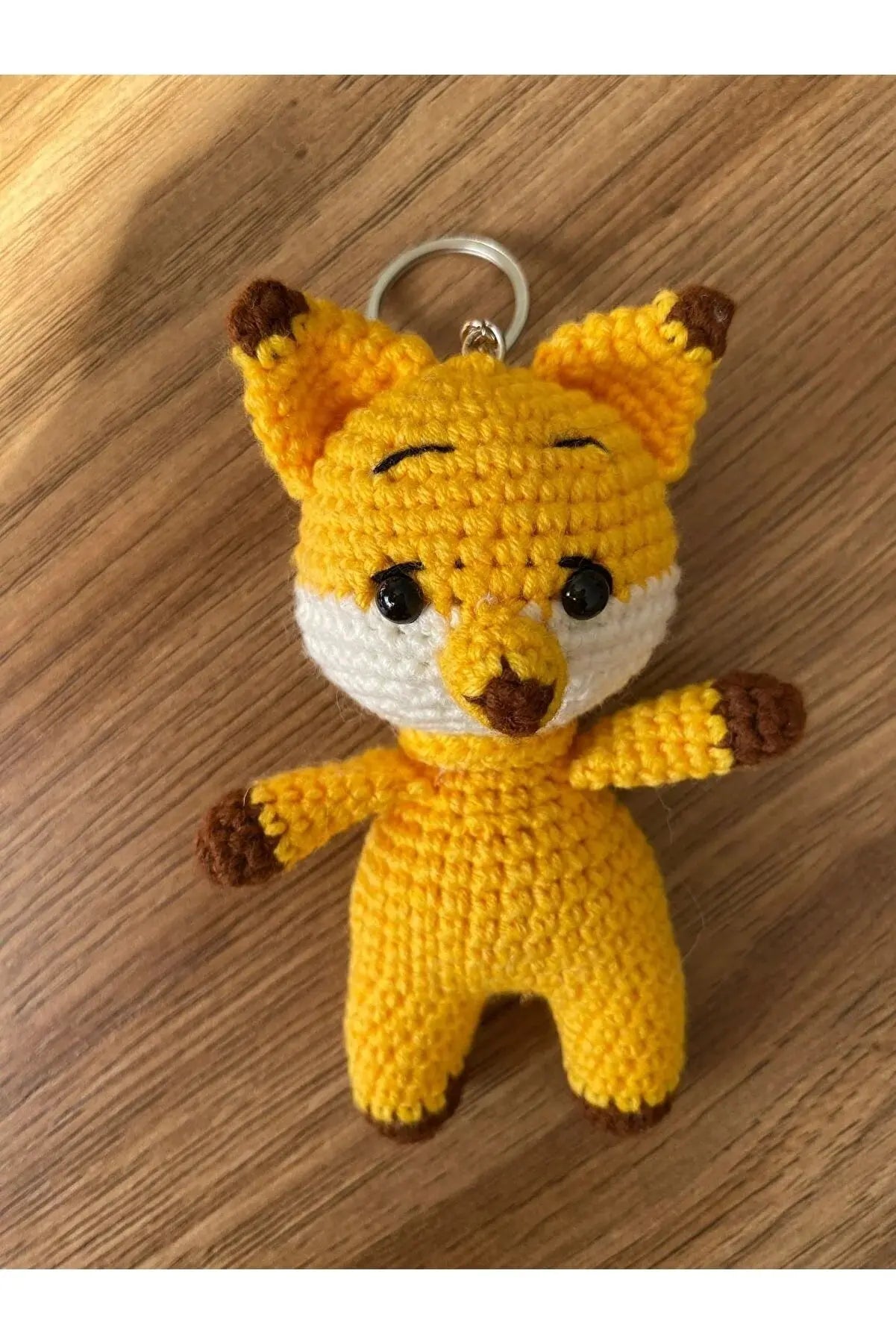 a crocheted keychain with a stuffed animal on it