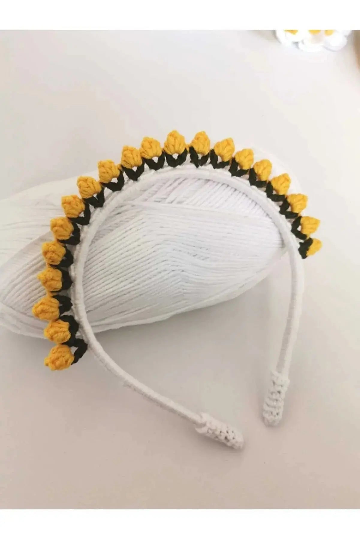 a white headband with yellow flowers on it