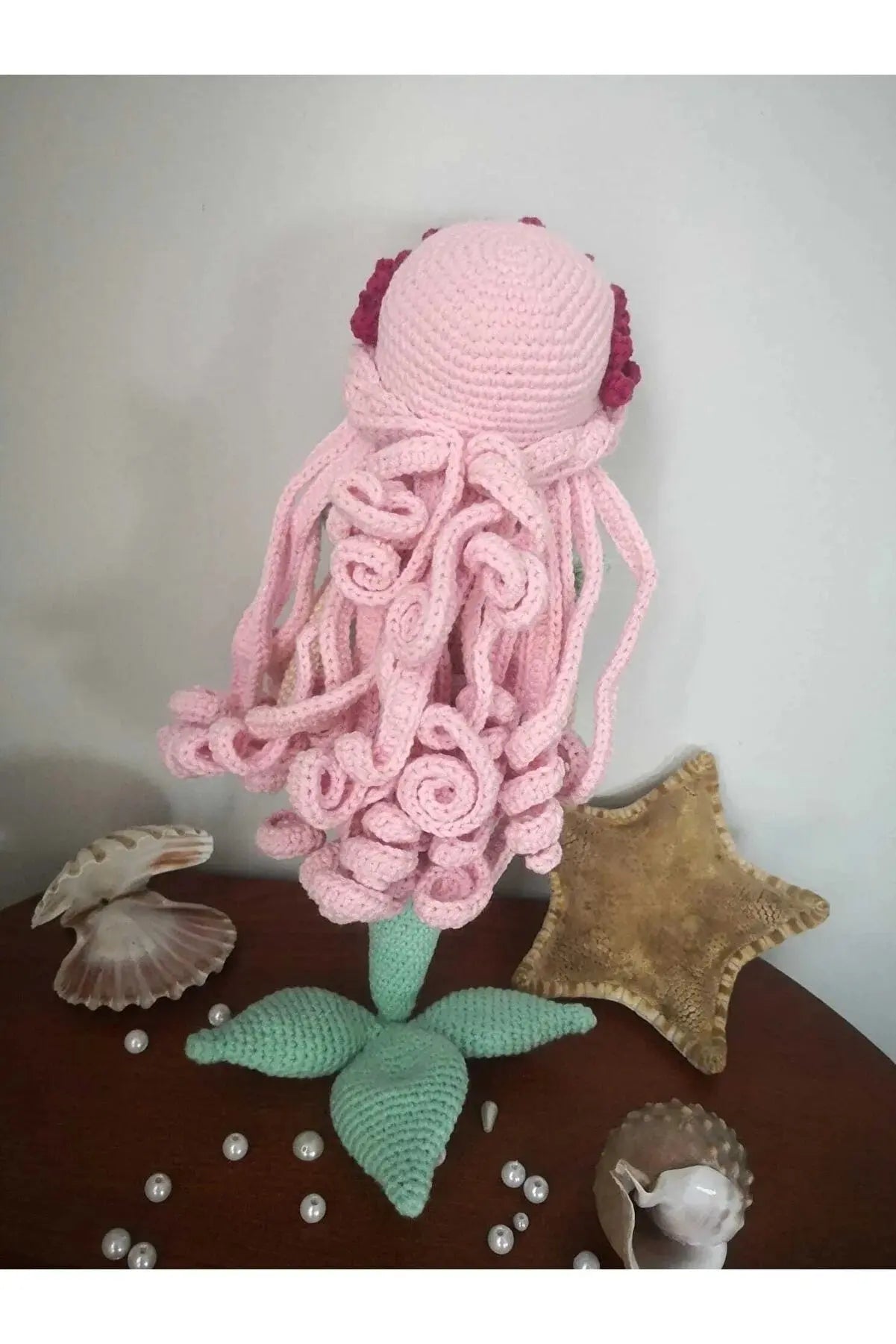 a crocheted octopus sitting on top of a wooden table