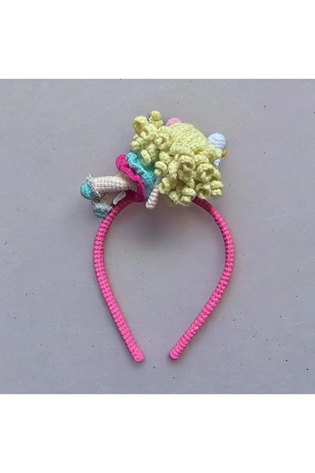 a crocheted headband with a poodle on top of it