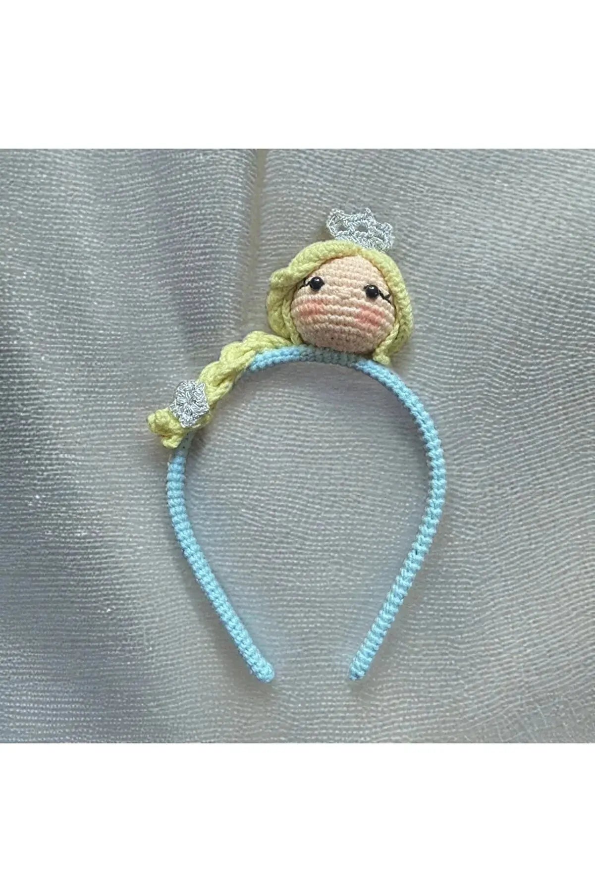 a knitted monkey headband with a blue cord