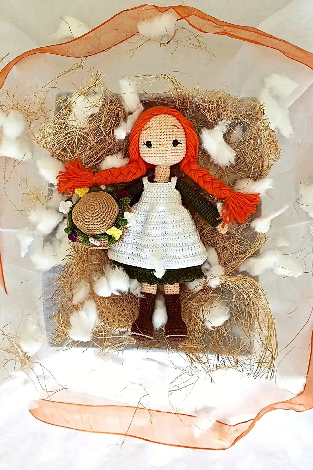 a doll with red hair and a white dress