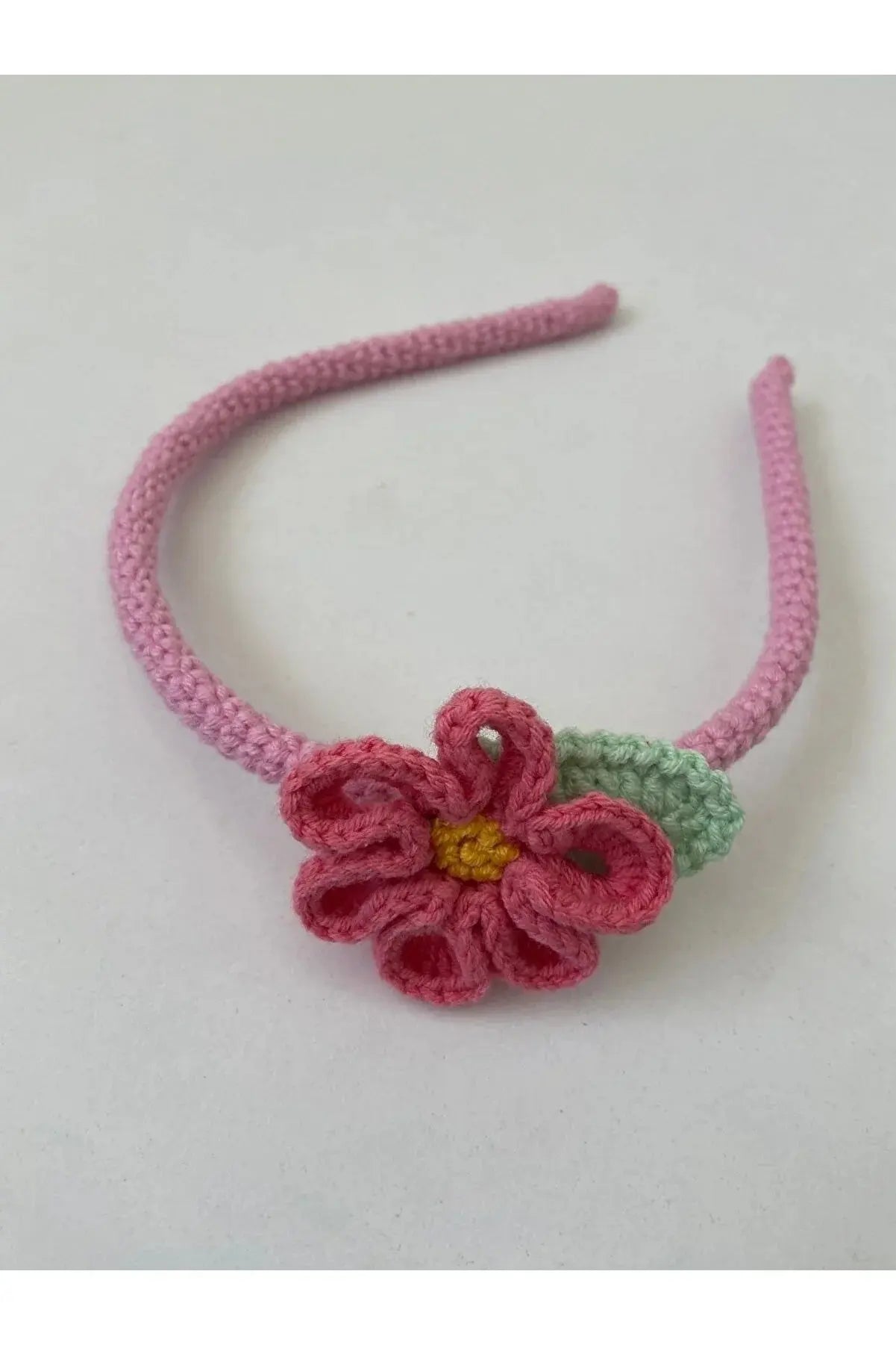 a crocheted headband with a flower on it