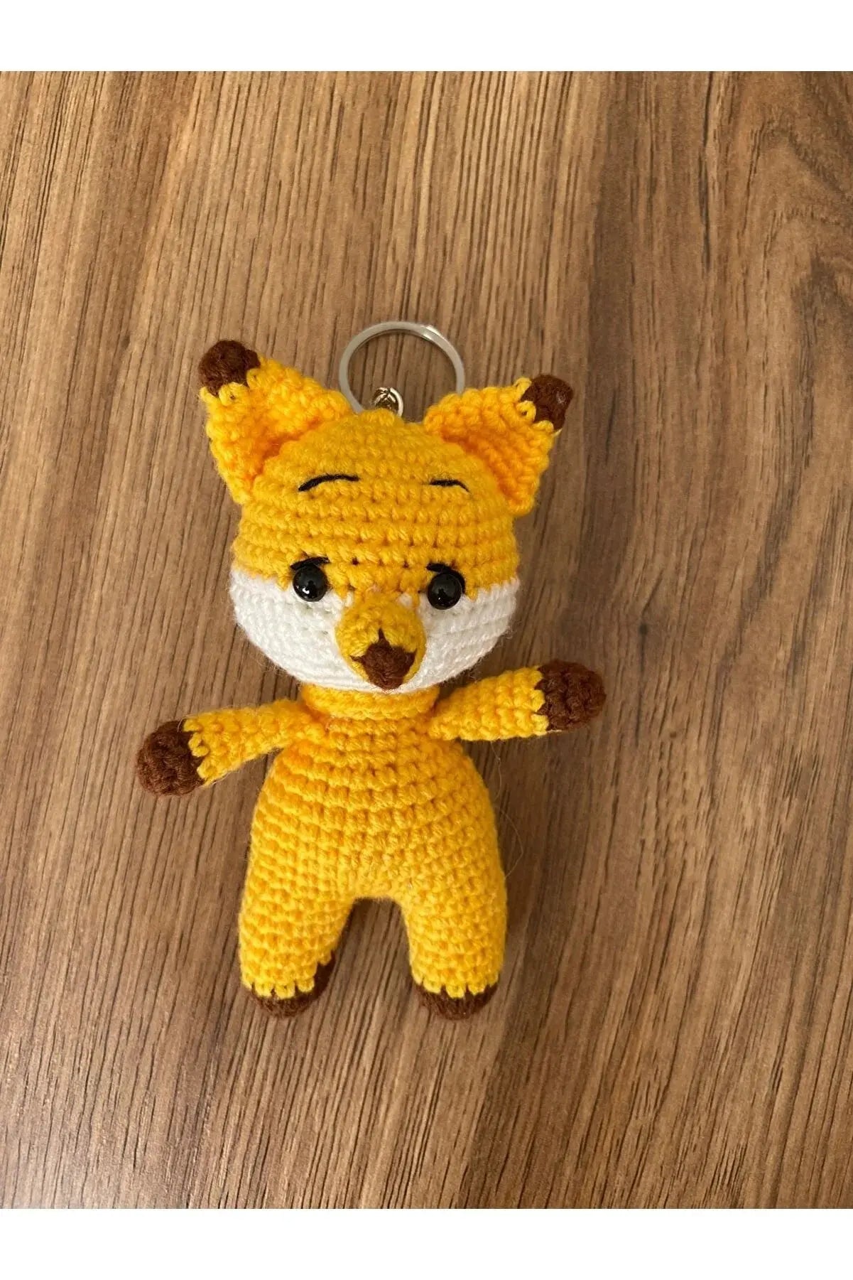 a crocheted keychain with a stuffed animal on it