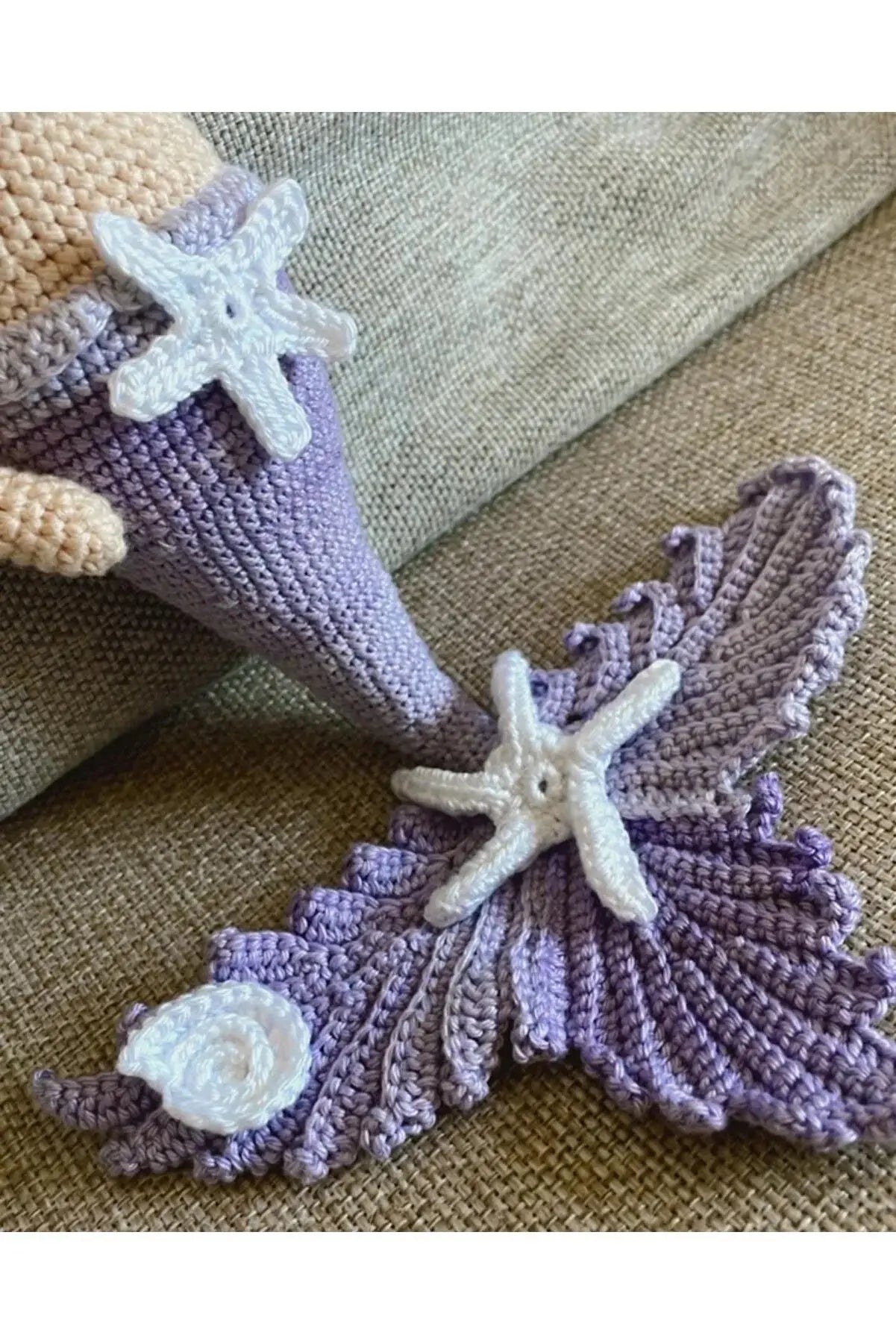 a crocheted starfish and seashell on a couch