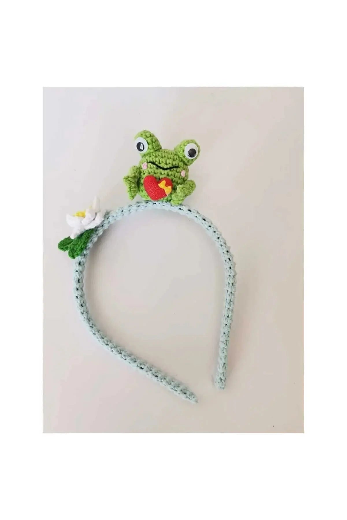 a crocheted headband with a frog on it