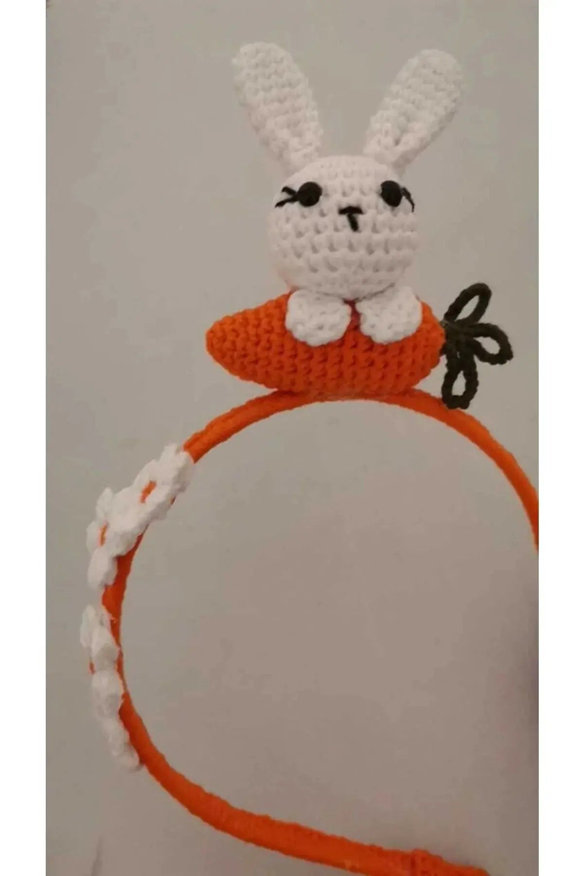 a crocheted headband with a rabbit on top of it