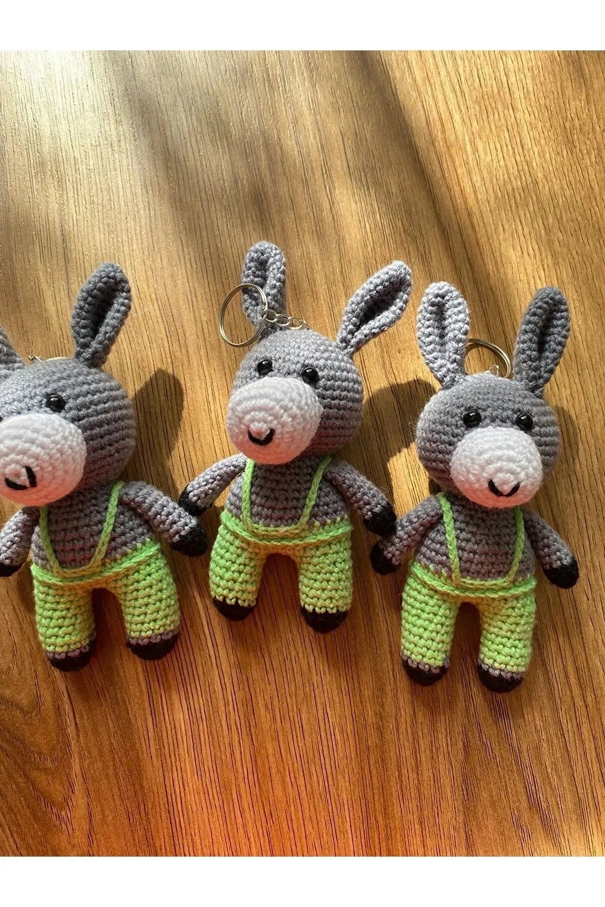 three crocheted stuffed animals sitting on top of a wooden table